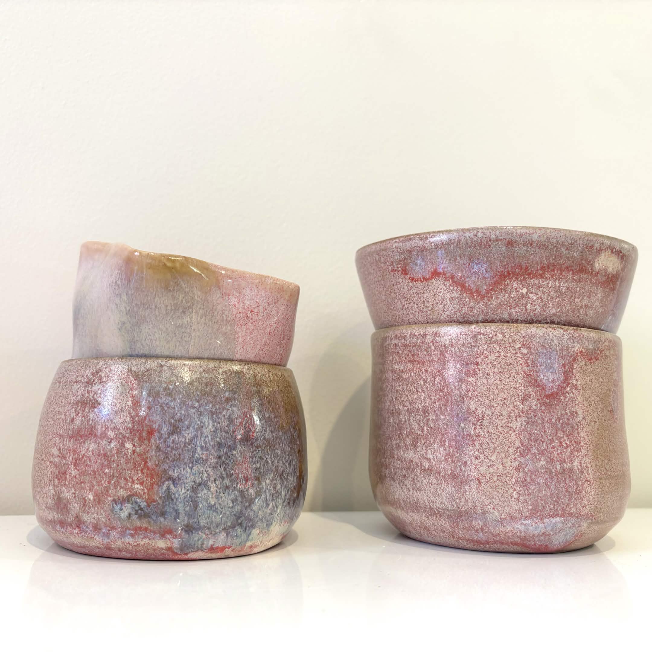 Stacked handmade pink ceramic vessels