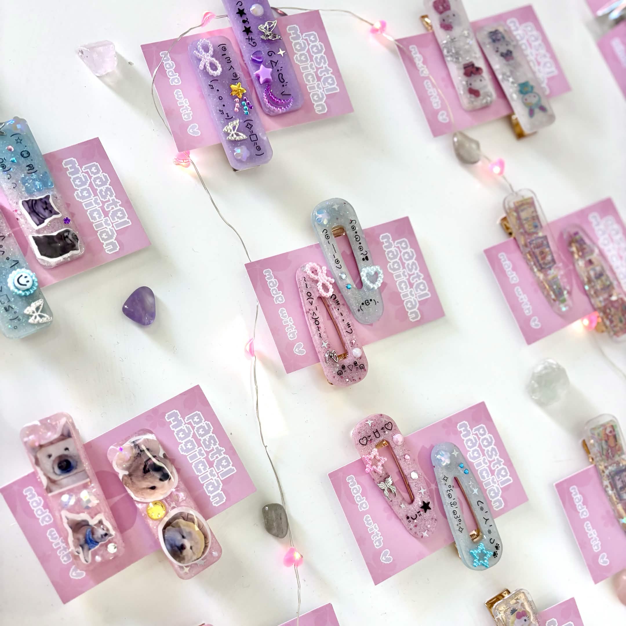 Assorted Pastel Magician hair clips arranged with pink lights